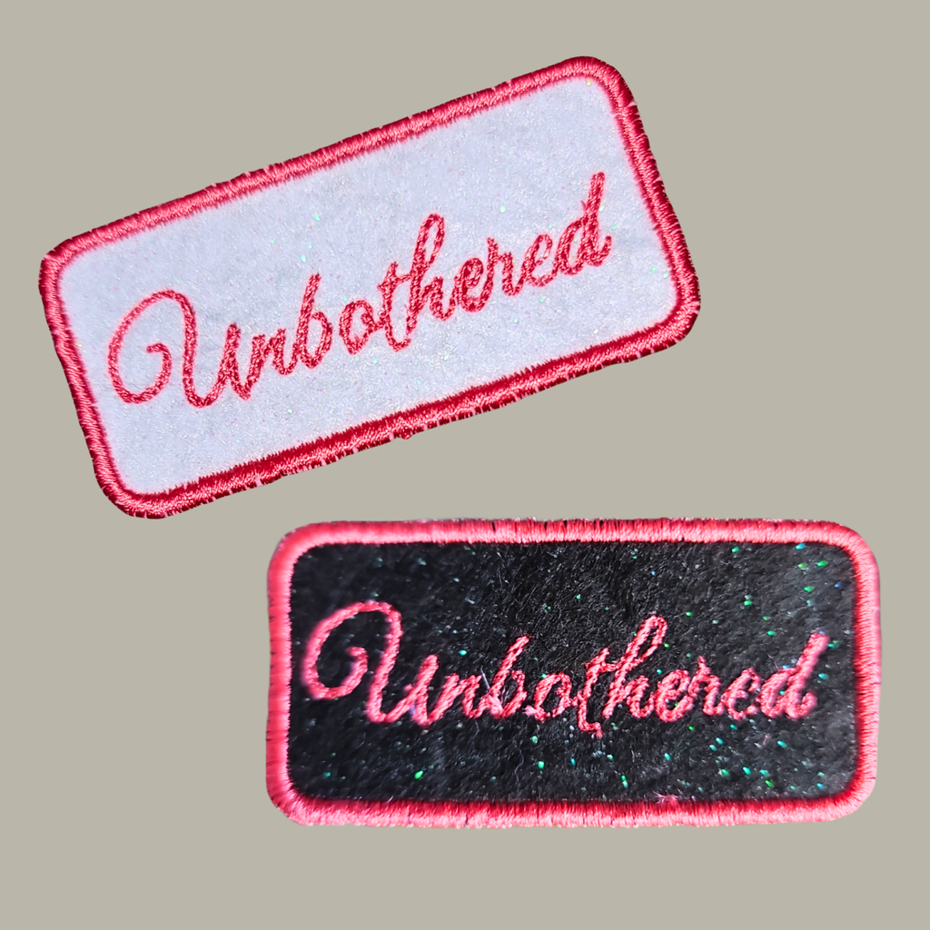 Unbothered” Embroidered Iron-On Patches shown in 2 colors