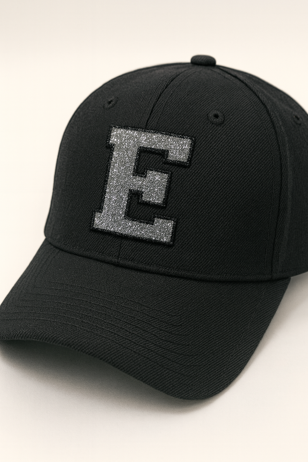 Silver Glitter varsity “Initial E” – Embroidered Iron-On Patch showned on black hat